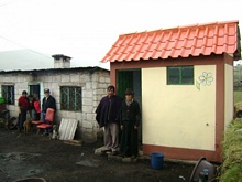 A family in front of the finished bathroom