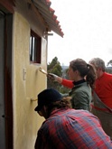 Our volunteers paint the bathroom walls freshly built