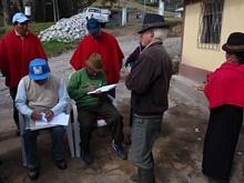 The president of the village of Chacambamba Quishuar signing the documents of ownership of the bathrooms