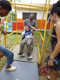 Vincenzo, representing Ecuaform, with Saul on the swing for wheelchairs