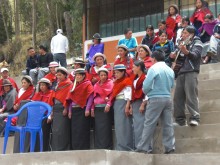 The community choir sings some local songs from the stands